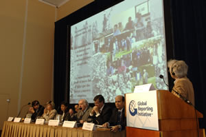 A panel on stage beneath a projected presentation