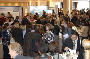 Conference participants talking around tables