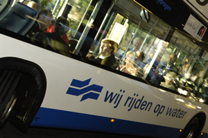 Conference participants seen through the windows of a bus